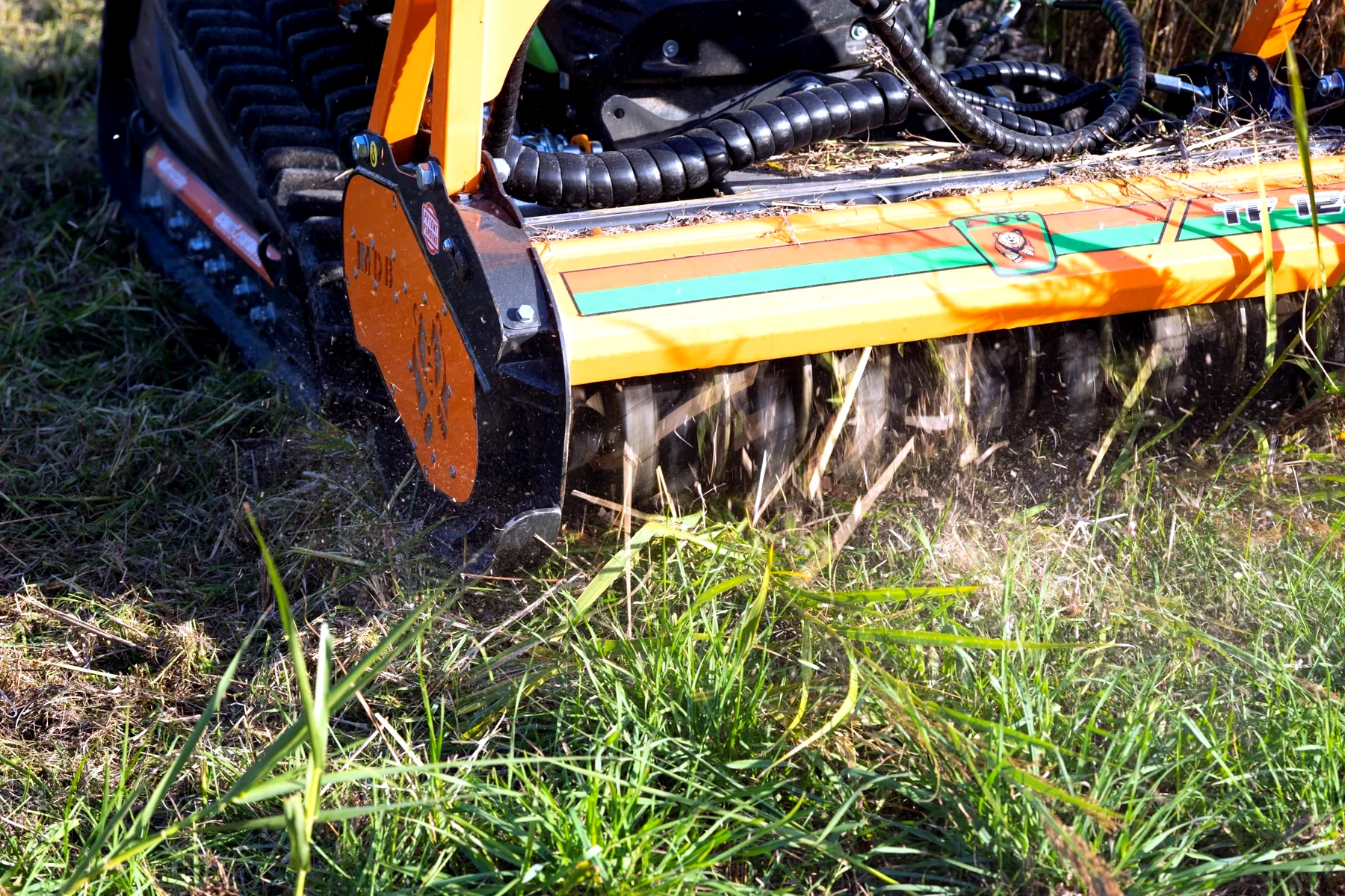 Close view of flail mowing equipment cutting vegetation